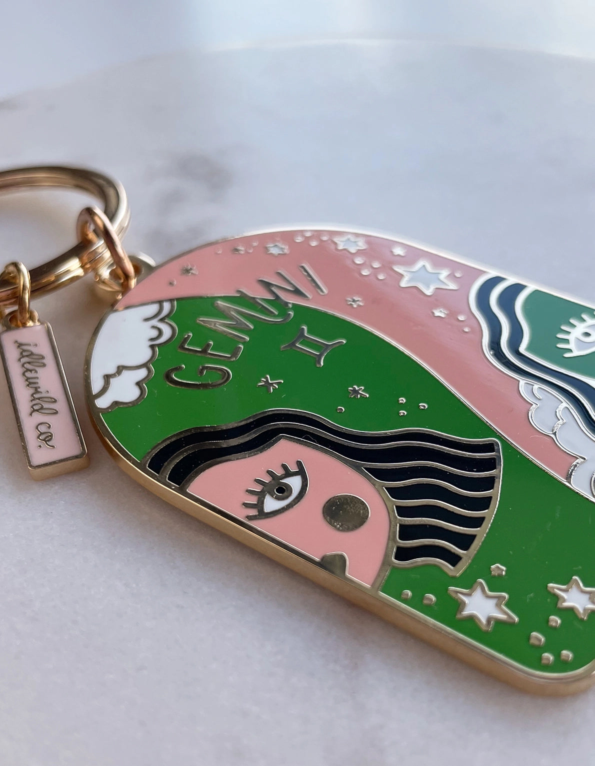 Keychain with Gemini zodiac design on a white background