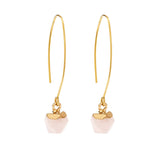 Gold earrings with pink stone drops on a white background