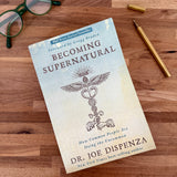 Becoming Supernatural Book on wood tabletop surface - Confía Collective