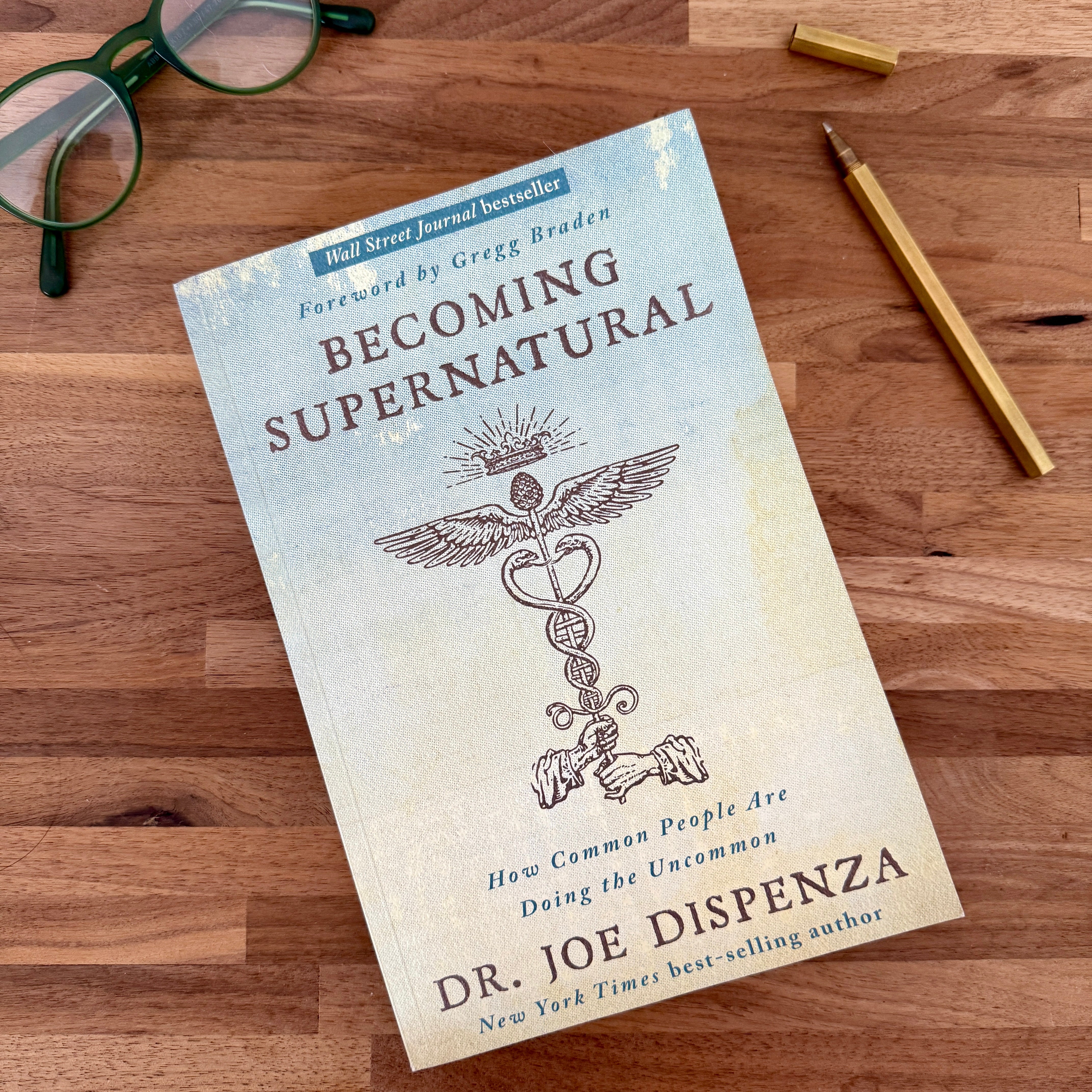 Becoming Supernatural Book on wood tabletop surface - Confía Collective