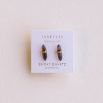 Jaxkelly smoky quartz earrings on a branded card with a beige background