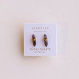 Jaxkelly smoky quartz earrings on a branded card with a beige background