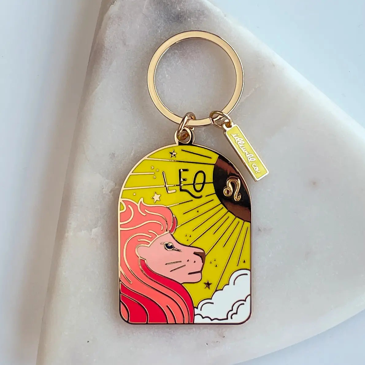 Keychain with Leo zodiac design on a marble surface
