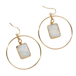 Gold hoop earrings with rectangular moonstone pendants in center, on a white background