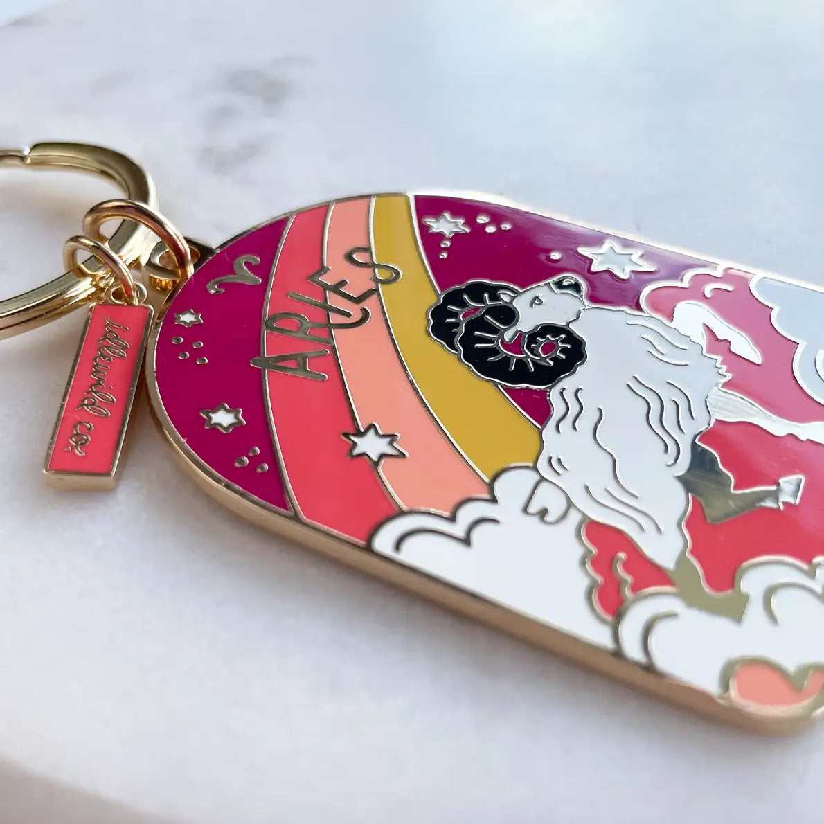 Keychain with Aries zodiac design on a white background
