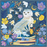 White Celestial Owl Puzzle on a blue background finished showing puzzle pieces