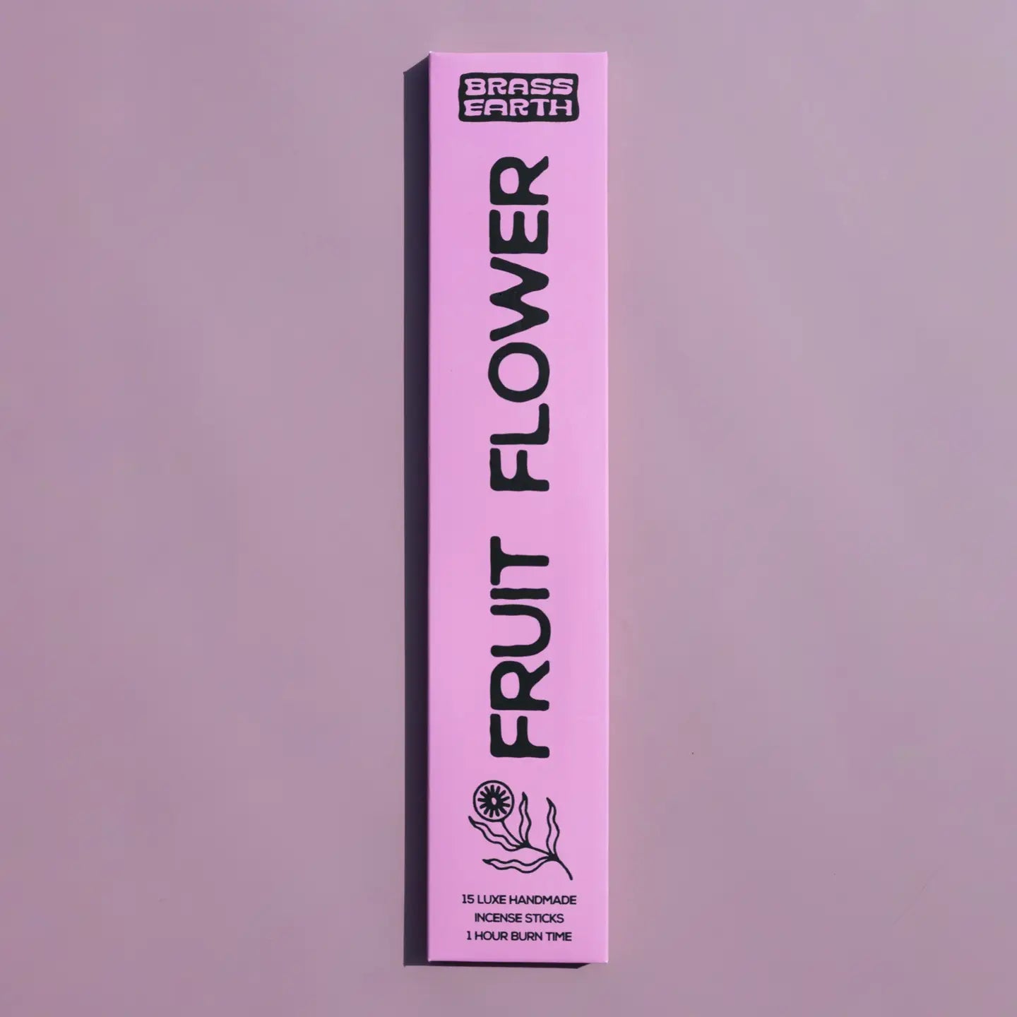 A tall, narrow pink box for Grass Earth Fruit Flower incense sticks, shown vertically against a matching dusty lavender background.