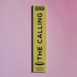 A tall, narrow yellow-green box for Brass Earth incense stands vertically against a soft pink background. The box features the brand name 'BRASS EARTH' at the top and the product name 'THE CALLING' printed vertically in large black letters, with a small black graphic below.