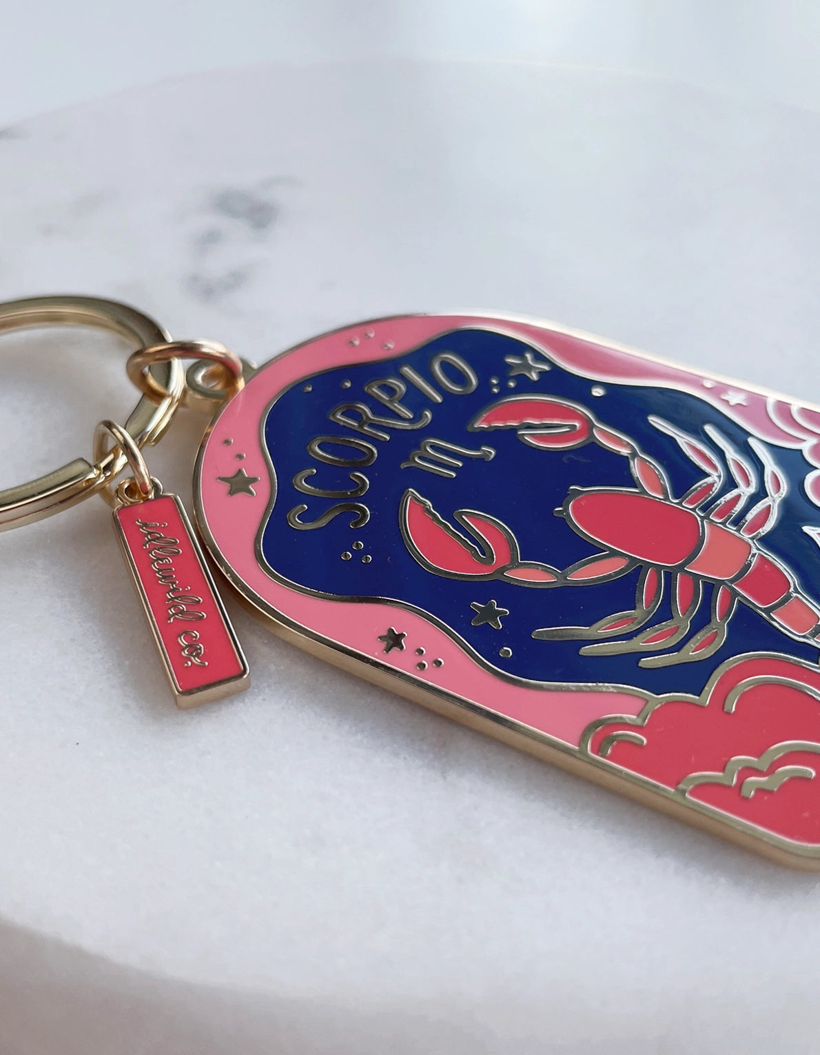 Keychain with lobster design and 'Scorpio' text on a white background