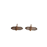 Pair of smoky quartz earrings with rose gold settings on a light gray background