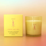 Candle and its packaging with 'LEO' branding on a gradient background