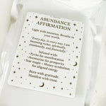 Abundance affirmation card on a white fabric background