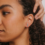 Close-up of a woman with curly hair and a neutral background