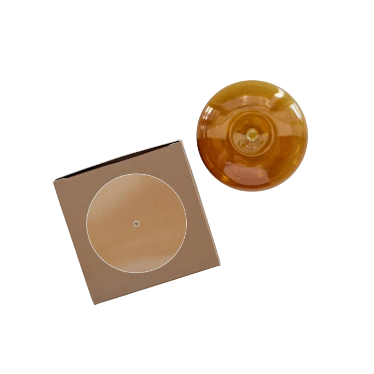 Amber glass incense holder dish on a marble surface