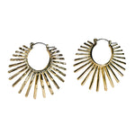 Gold hoop earrings with sunburst design on a light background