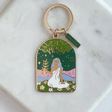 Colorful brass Virgo keychain with a woman sitting on a marble background