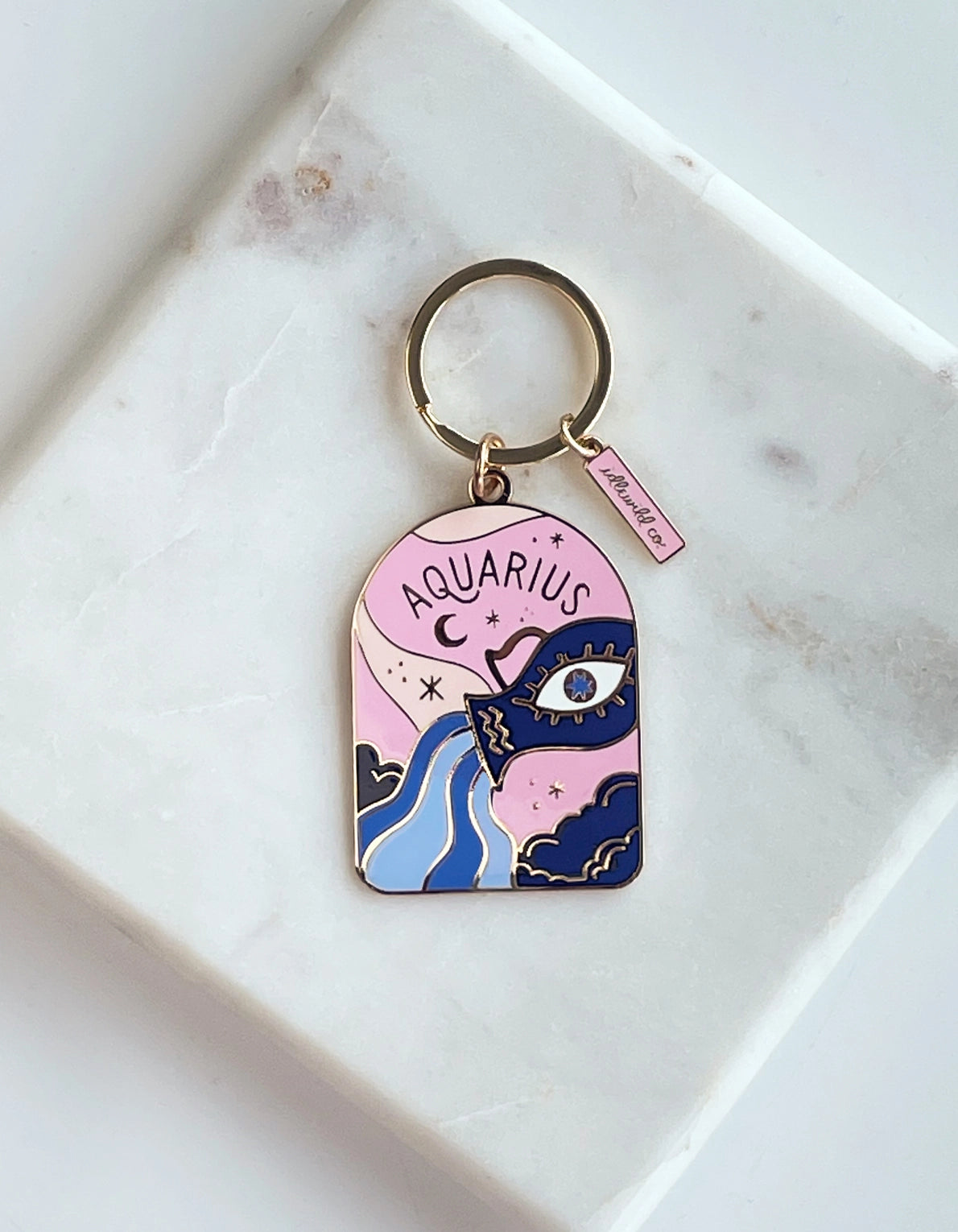 Aquarius zodiac keychain on a marble surface