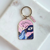 Aquarius zodiac keychain on a marble surface