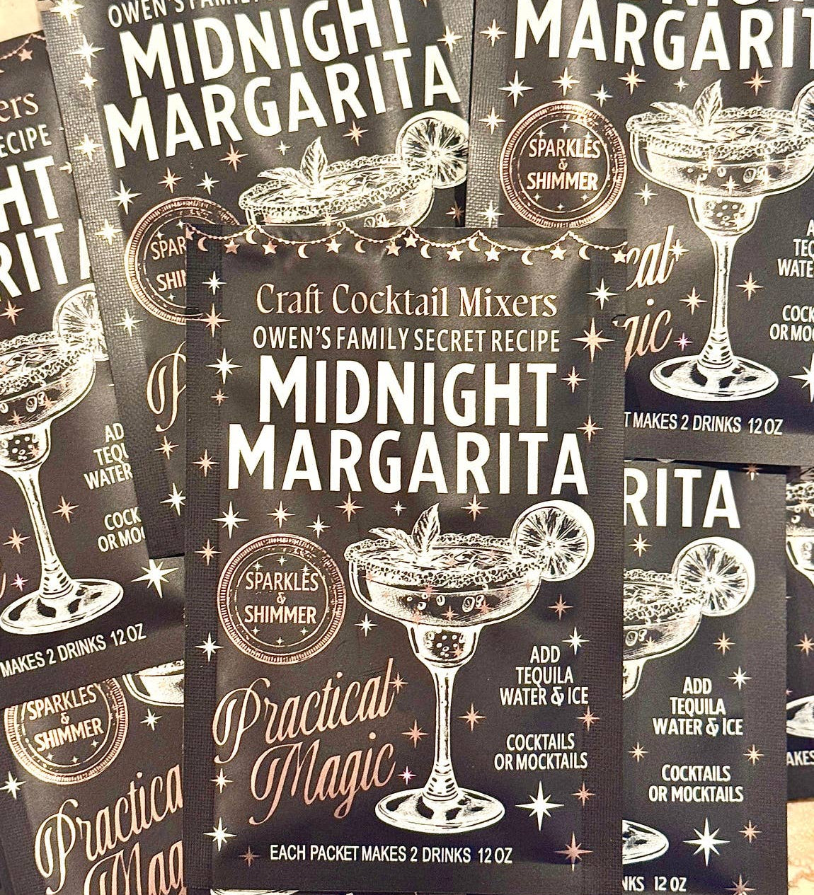 Packages of Craft Cocktail Mixers with 'Midnight Margarita' and 'Practical Magic' branding.