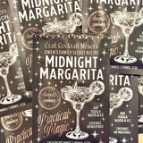 Packages of Craft Cocktail Mixers with 'Midnight Margarita' and 'Practical Magic' branding.