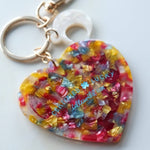 Colorful heart-shaped keychain charm with a white background