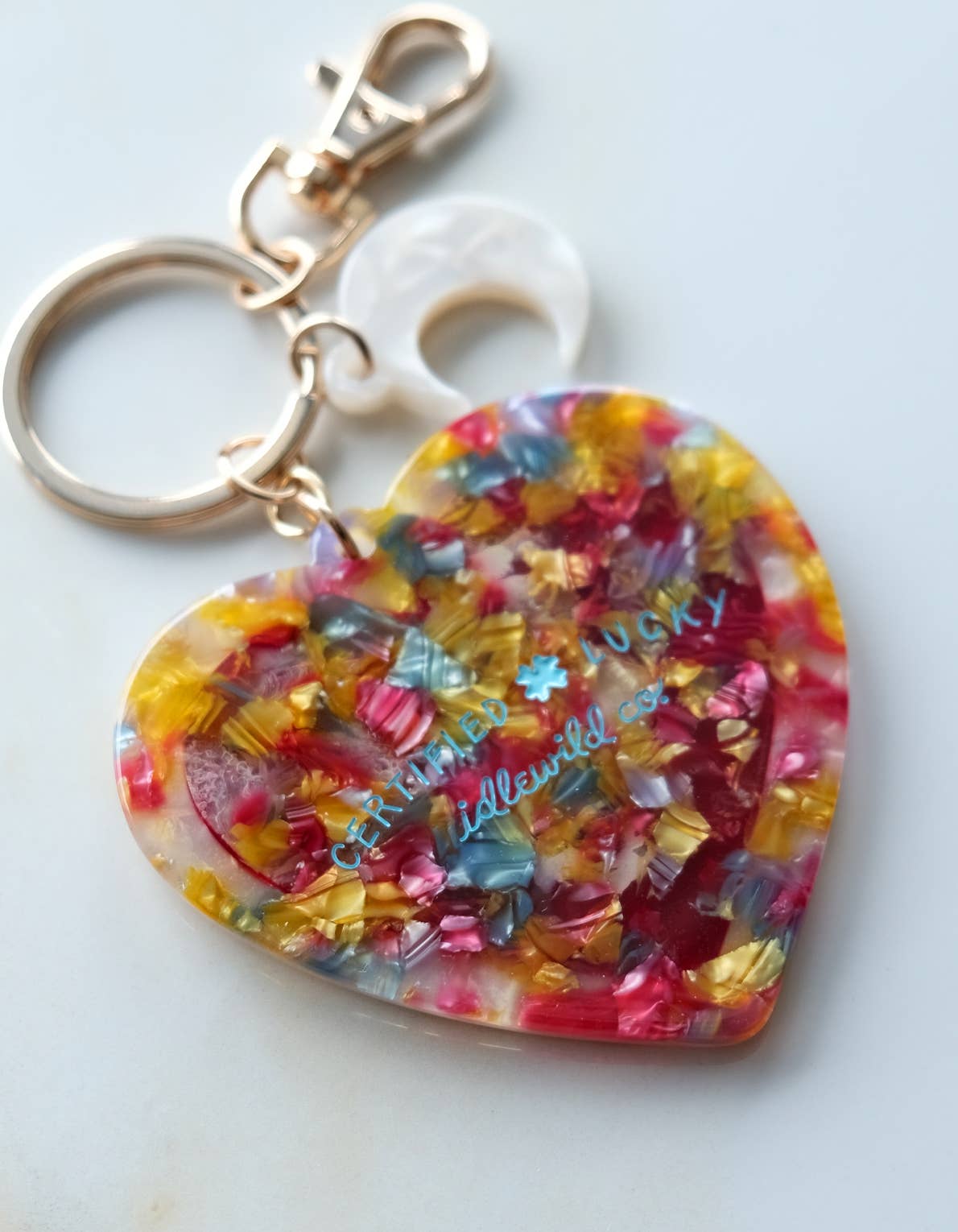 Colorful heart-shaped keychain charm with a white background