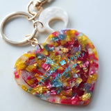 Colorful heart-shaped keychain charm with a white background