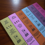 Set of colorful incense boxes with text and graphics on a wooden surface