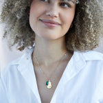 Model with white shirt wearing  Gold Emerald like Birthstone Gold Necklace - Confía Collective
