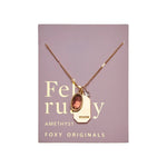 February Gold Birthstone Necklace on purple card- Confía Collective