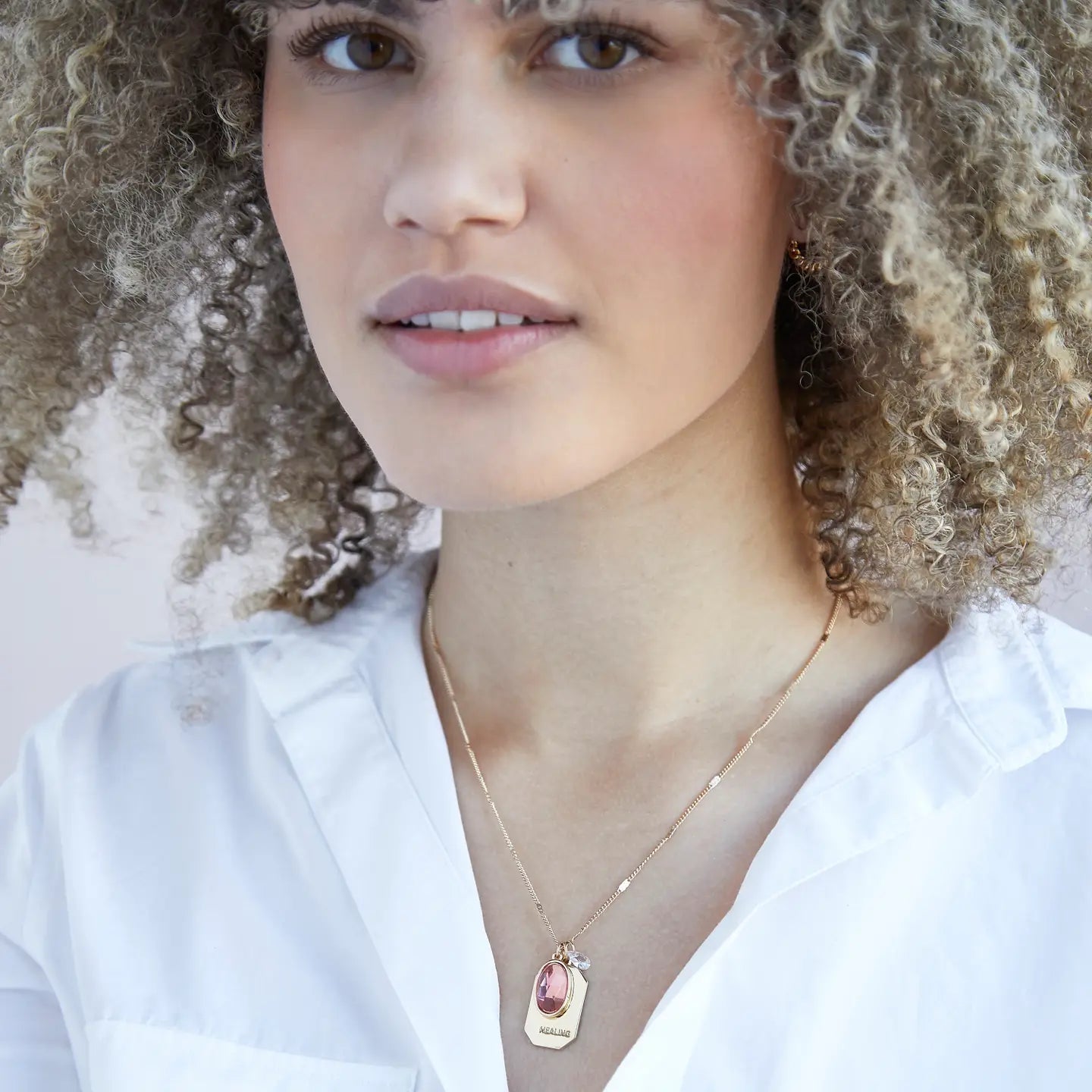 Model with white shirt wearing  Gold  Birthstone Gold "healing" Necklace - Confía Collective
