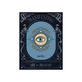 Book cover of 'Manifesting: Live Your Dream Life' by Galila Thalassina featuring an eye with a laurel wreath and stars on a blue background.
