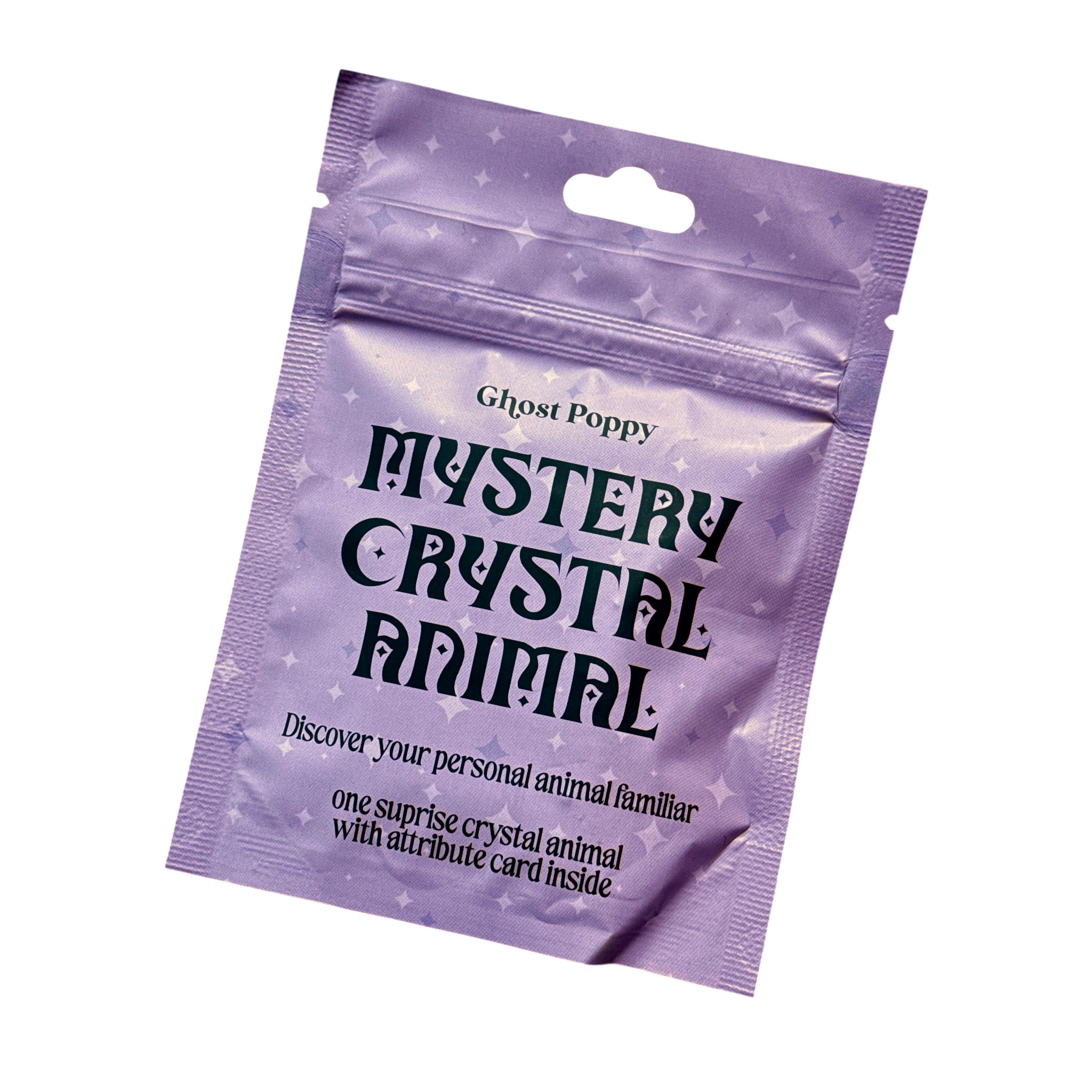 A purple resealable pouch labeled 'Ghost Poppy Mystery Crystal Animal' with black gothic text and star speckles, shown on a plain white background.