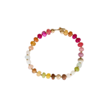 Beaded bracelet with a rainbow of different gemstones and a gold clasp on a white background