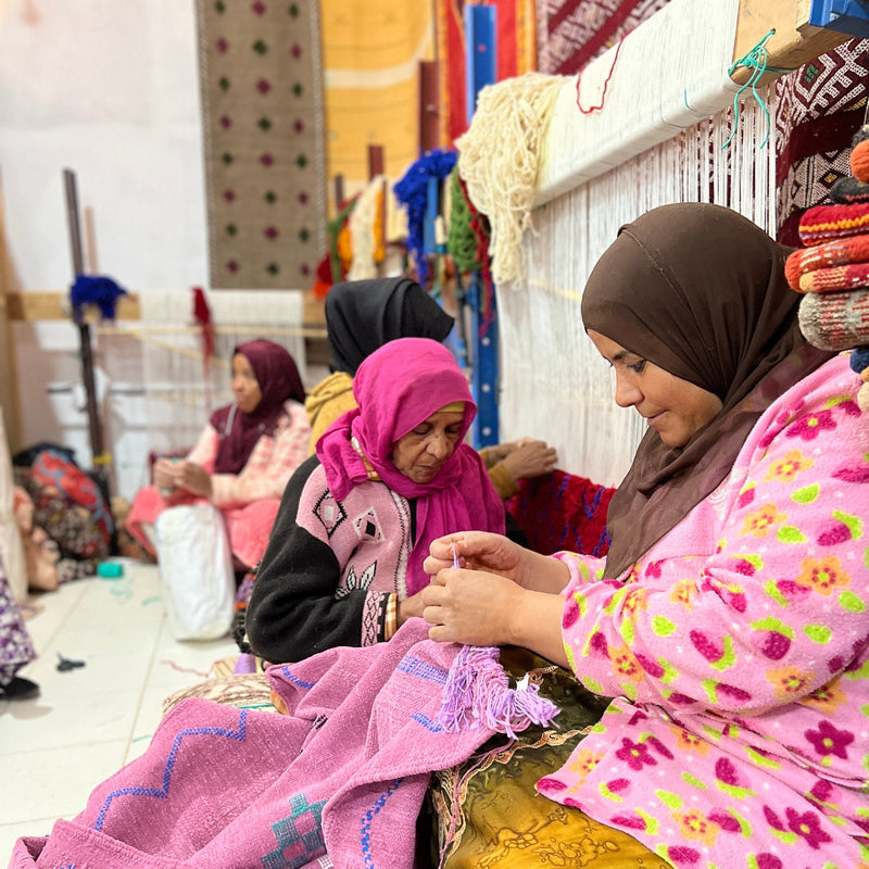 Berber women hand looming Moroccan rugs