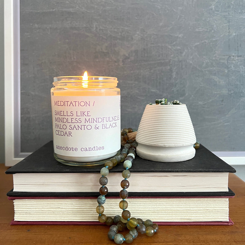 Meditation candle smells like minful mindfulness.  Palo Santo & Black Cedar - Light this candle and watch your worries melt away. Misted heliotrope, grey quartz, and amber bring clarity and fresh perspectives. Smoky base notes of palo santo and black cedar add depth and texture to the fragrance for a modern take on mindfulness.