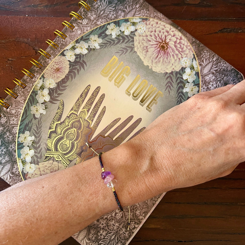 love + happiness iridescent purple beaded bracelet.