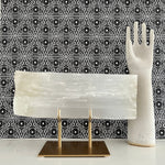 Selenite slab comes magnificently displayed on a gold stand.