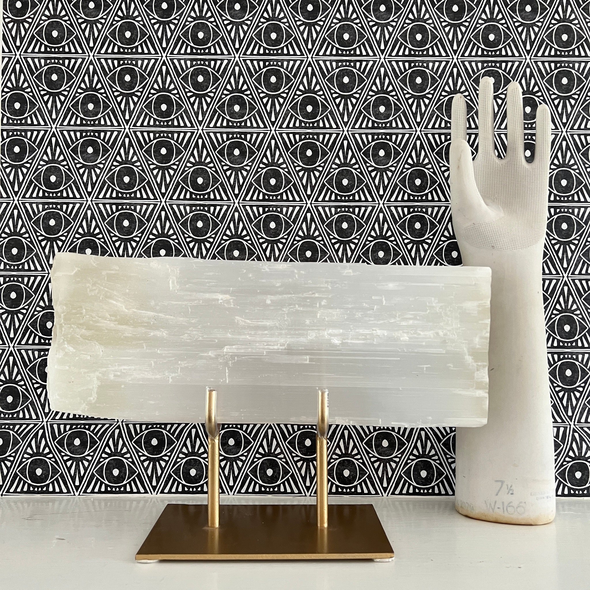Selenite slab comes magnificently displayed on a gold stand.