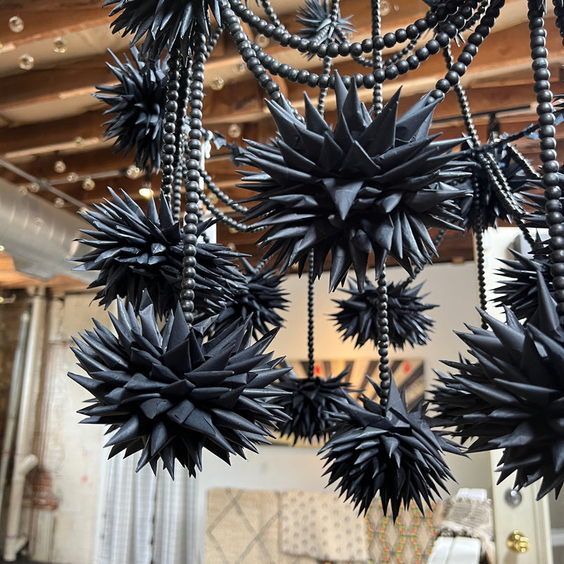 Bring happiness and whimsy into your home with this amazing black bead Pajaki chandelier.