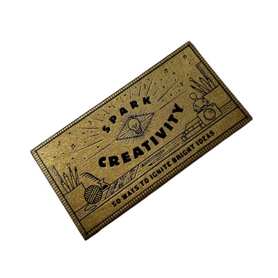 Spark Creativity in a box: accessible prompts in a pick-me-up package that are applicable to any type of creative pursuit, be it visual art, music, writing, or any other practice that requires idea-generation.