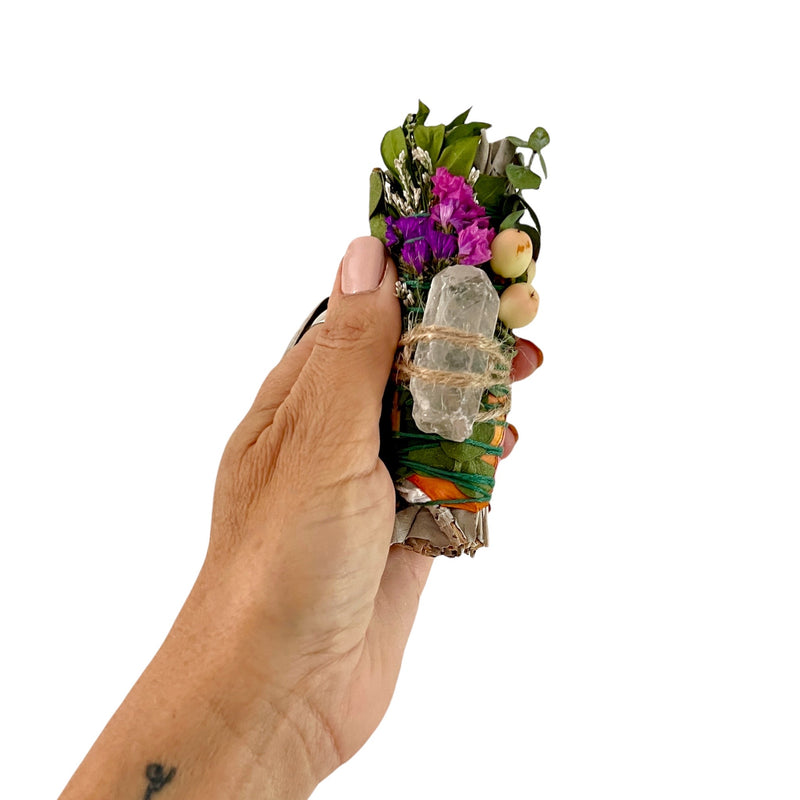 Hand-crafted smudging sage wand with clear quartz crystal and gorgeous wildflowers, rose petals and eucalyptus.