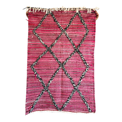 Hot pink, red, black and cream stripe with black and cream diamonds Moroccan hand looped rug of 100% wool.