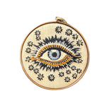 This cream embroidered lucky eye is an all year ornament to cast away negative energy.