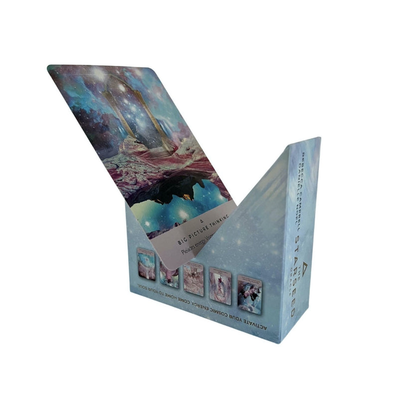 The Starseed Oracle 53-card deck and guidebook by Rebecca Campbell with artwork by Danielle Noel. Picture shows card box as stand for displaying cards.