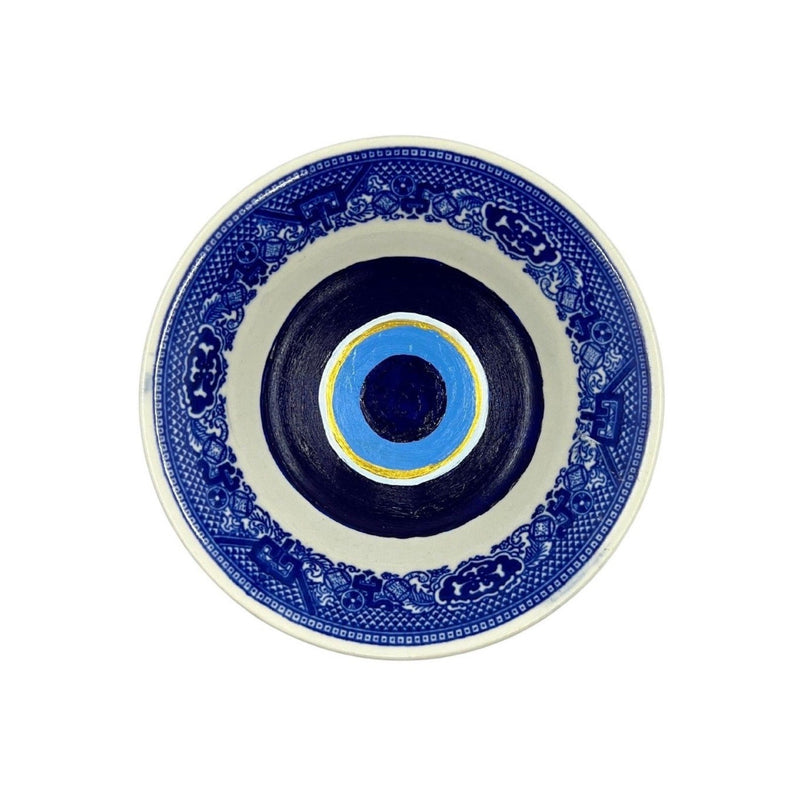 Antique vintage blue plates have been given new life with hand-painted evil eyes. Just the thing we need that we didn&