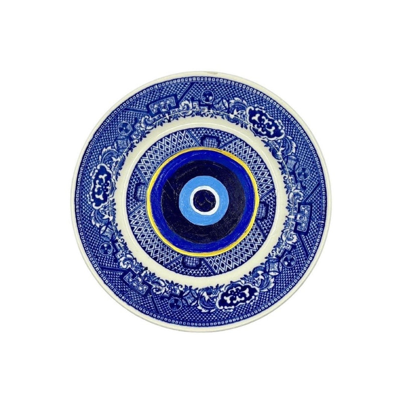 Antique vintage blue plates have been given new life with hand-painted evil eyes. Just the thing we need that we didn&