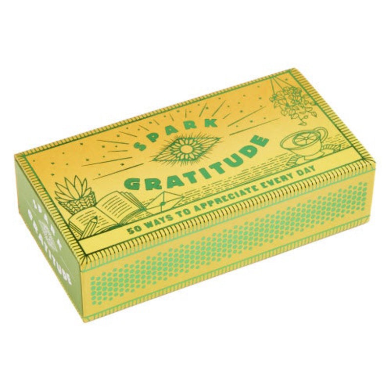 The Spark Gratitude shimmering matchbox contains 50 faux matchsticks with prompts for appreciating your surroundings, expressing thanks, and giving back. 